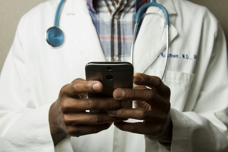 Physician consulting patient regarding healthcare plan tiers and cost reductions